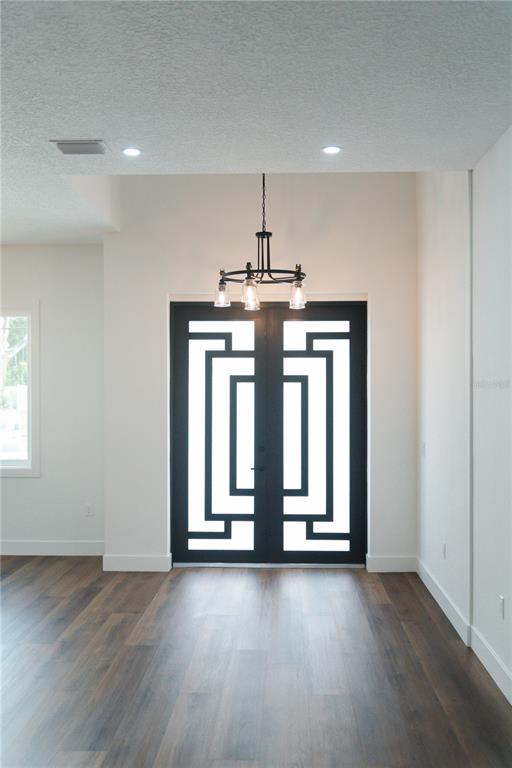 15364 Newport Road Clearwater, FL 33764 - Photo 26 of 50 an empty room with wooden floor and windows