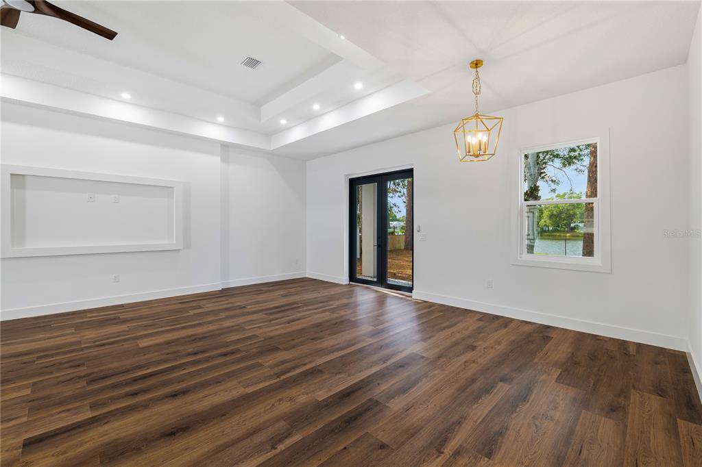 15364 Newport Road Clearwater, FL 33764 - Photo 29 of 50 an empty room with wooden floor and windows