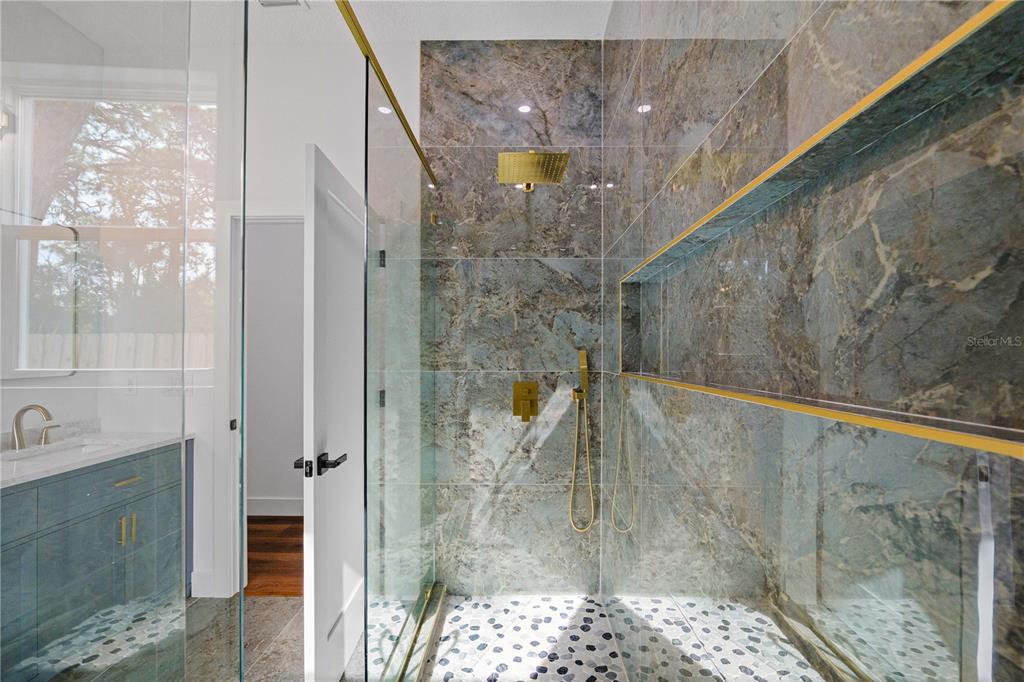 15364 Newport Road Clearwater, FL 33764 - Photo 32 of 50 a bathroom with a glass shower door
