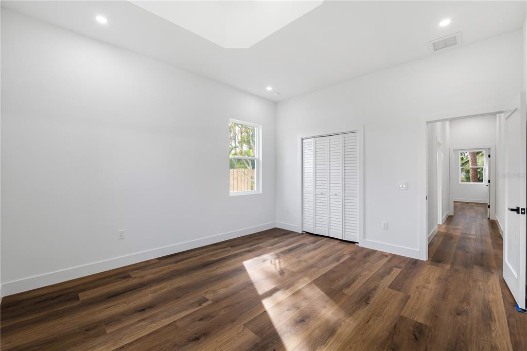 15364 Newport Road Clearwater, FL 33764 - Photo 34 of 50 an empty room with wooden floor and windows