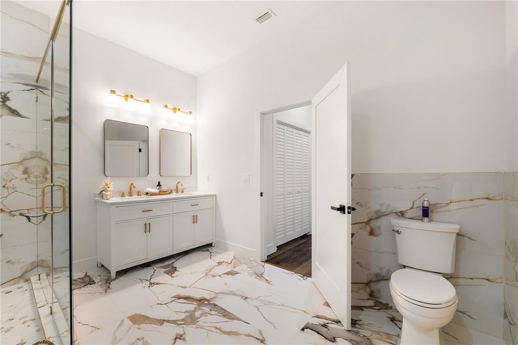 15364 Newport Road Clearwater, FL 33764 - Photo 39 of 50 a bathroom with a sink mirror vanity and toilet