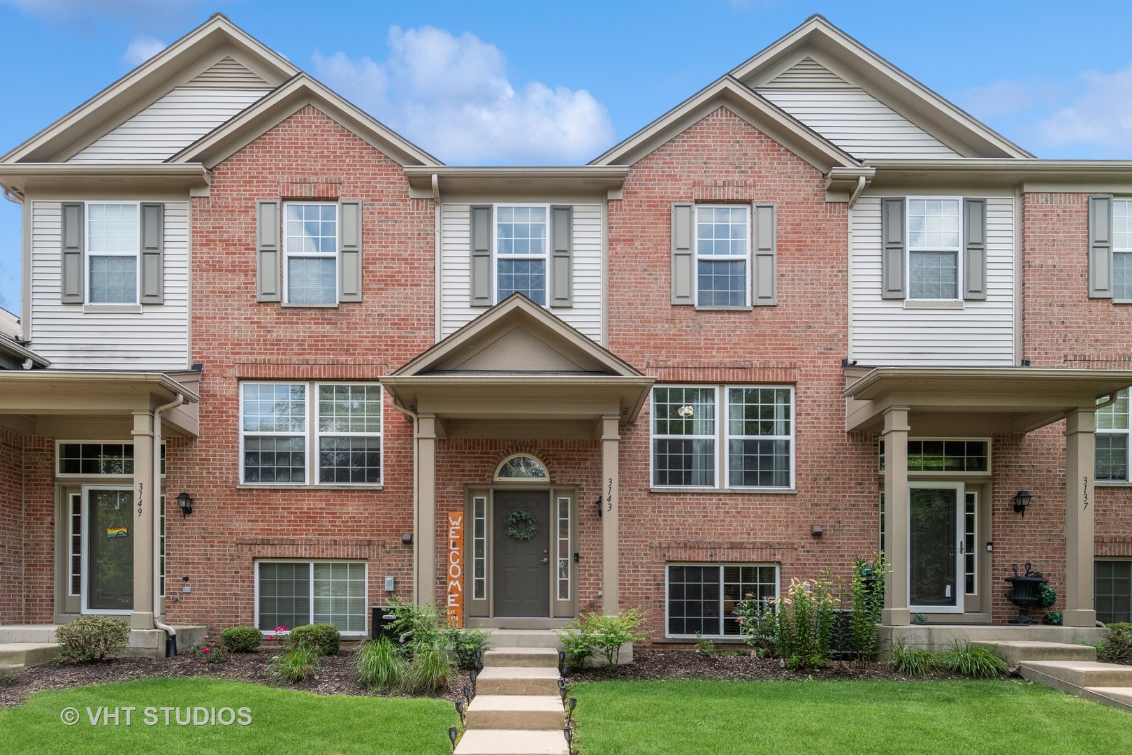front view of brick house with a yard