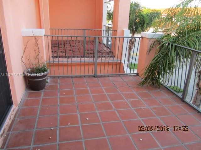 20820 San Simeon Way, Unit 26G Miami, FL 33179 - Photo 4 of 6 a view of a balcony with wooden floor