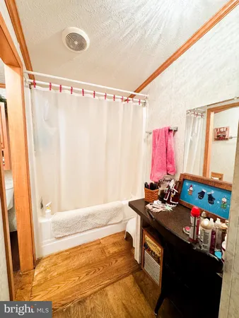 a bathroom with a sink a bath tub and a shower