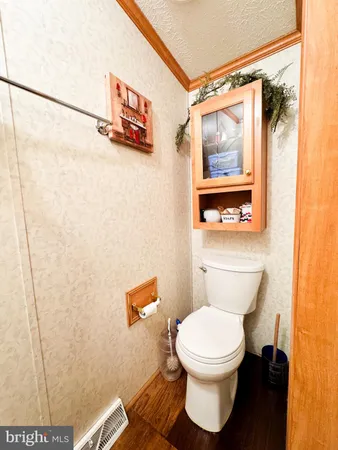 a white toilet sitting next to a shower curtain