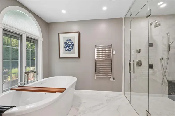 a view of a bathroom with a tub and shower