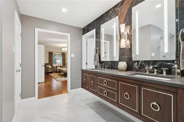 a spacious bathroom with a sink double vanity and a mirror
