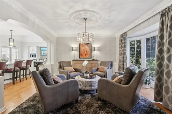 a living room with furniture a chandelier and a chandelier