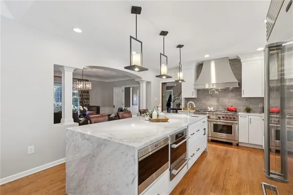 a kitchen with stainless steel appliances granite countertop a stove and a sink
