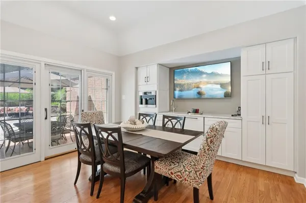 a view of a dining room with furniture and wooden floor