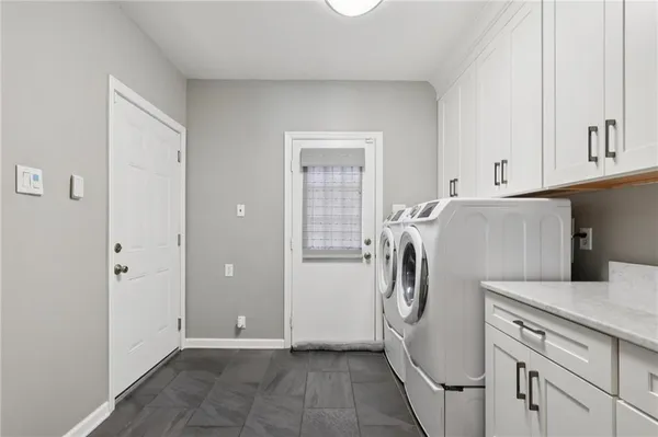 a view of kitchen with refrigerator and washer