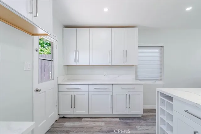 a view of a kitchen with white cabinets