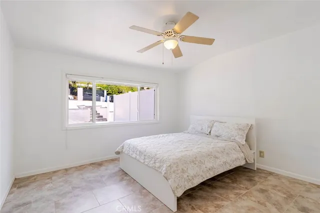 a bedroom with a bed and window