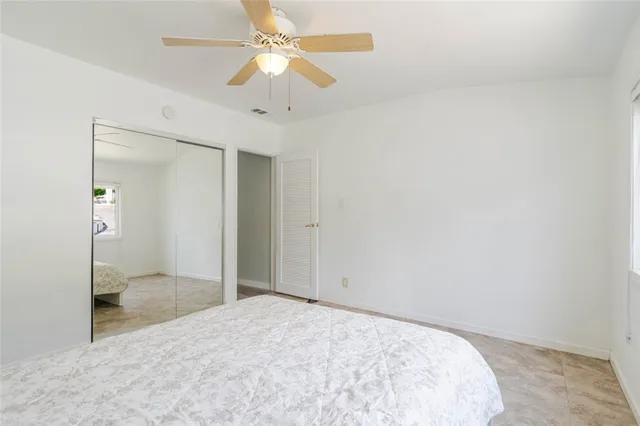 an empty room with fan and entrance