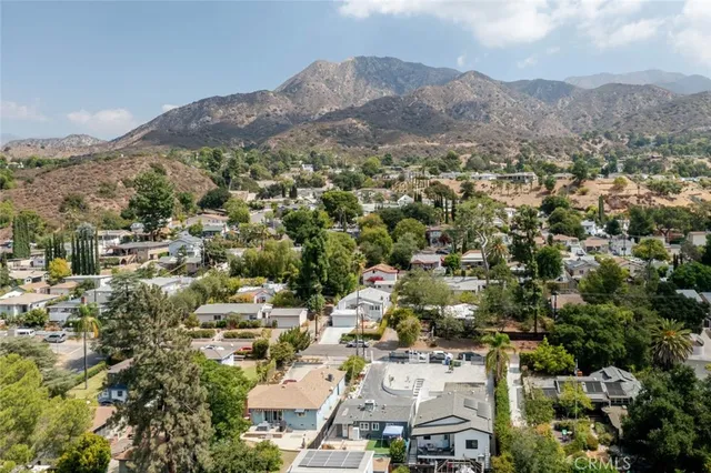 an aerial view of residential house and green space