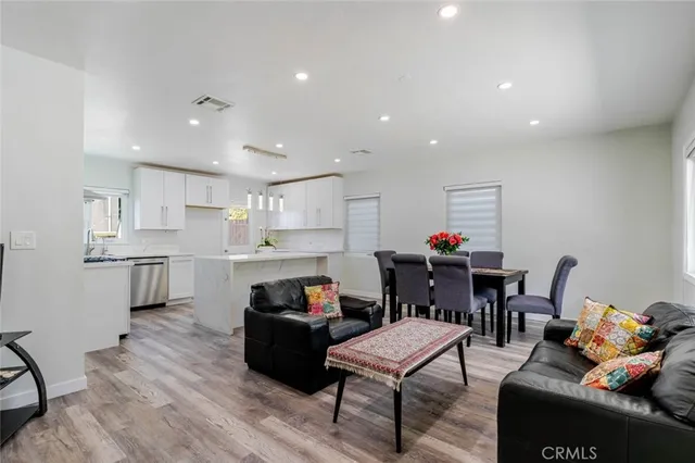 a living room with furniture and a kitchen view