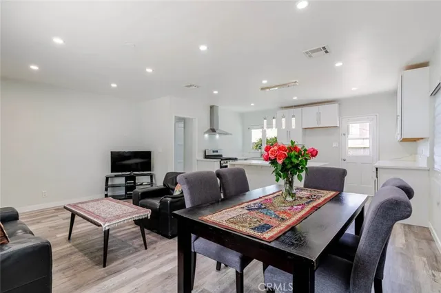a living room with furniture potted plant and a flat screen tv