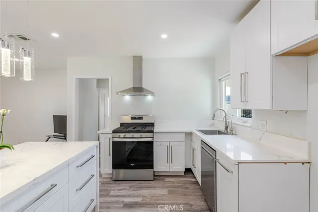 a kitchen with a stove sink and cabinets