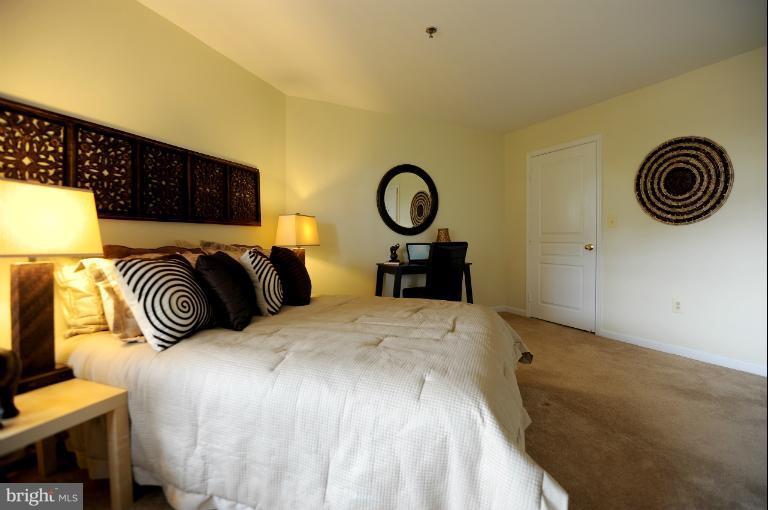 5563 Seminary Road, Unit 406 Falls Church, VA 22041 - Photo 2 of 18 a bed room with a bed and a lamp