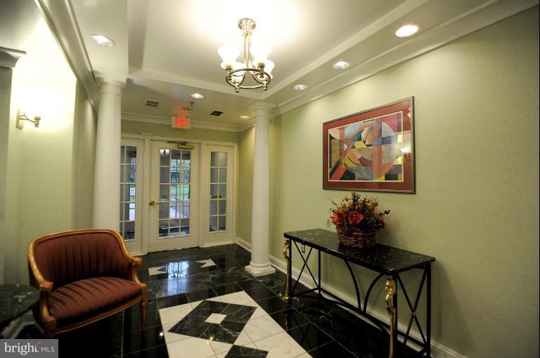 5563 Seminary Road, Unit 406 Falls Church, VA 22041 - Photo 13 of 18 a living room with furniture and a chandelier