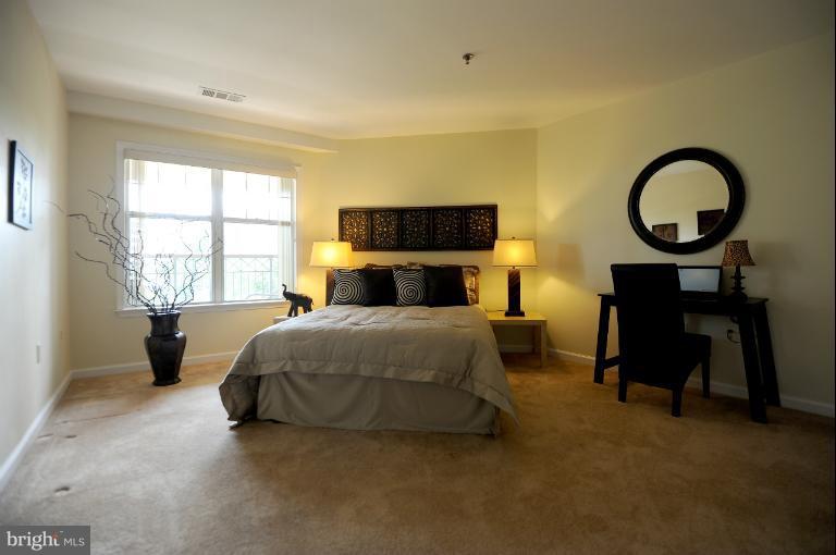 5563 Seminary Road, Unit 406 Falls Church, VA 22041 - Photo 3 of 18 a bedroom with a bed a dresser and a window