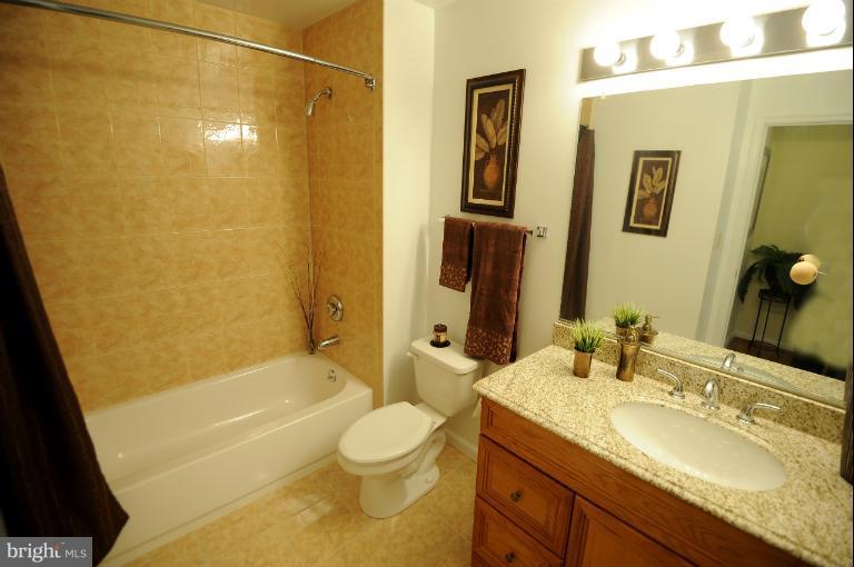 5563 Seminary Road, Unit 406 Falls Church, VA 22041 - Photo 5 of 18 a bathroom with a granite countertop sink toilet and shower