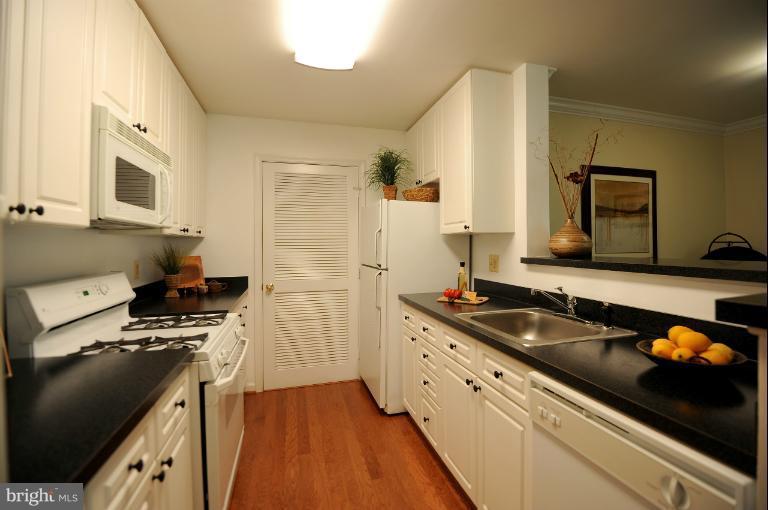 5563 Seminary Road, Unit 406 Falls Church, VA 22041 - Photo 7 of 18 a kitchen with stainless steel appliances a sink stove and refrigerator