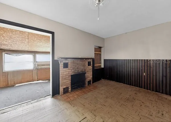 an empty room with floor to ceiling window and an empty room