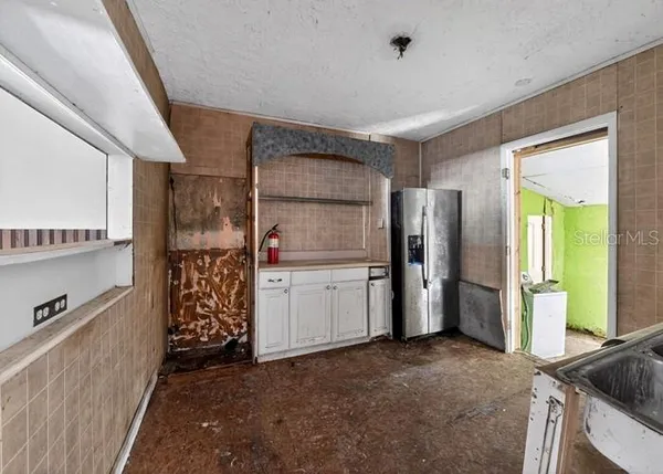 a kitchen with refrigerator and window