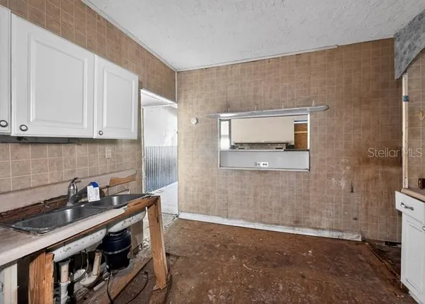 a kitchen with stainless steel appliances a stove a sink and a refrigerator