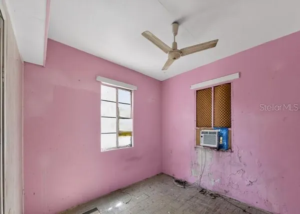 a view of a livingroom with a window and a ceiling fan