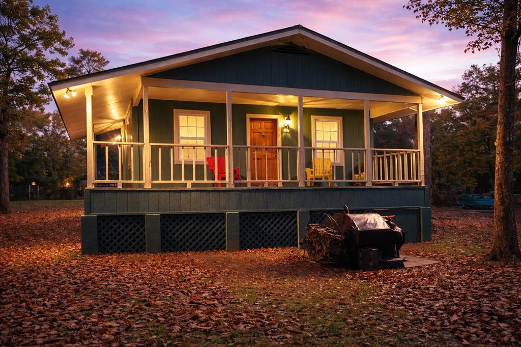 Back of house at dusk featuring a porch