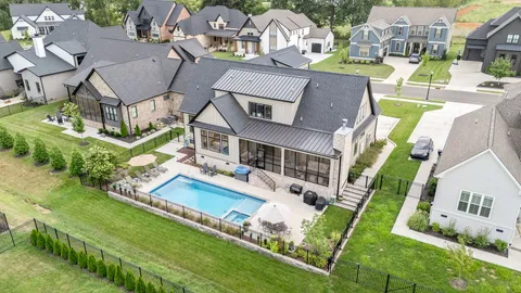an aerial view of residential houses with yard