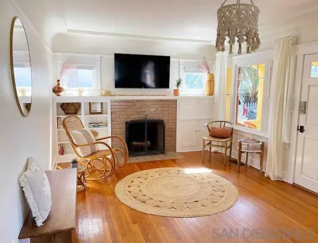a living room with furniture a flat screen tv and a fireplace