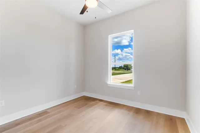 a view of a room with wooden floor chandeliers and window