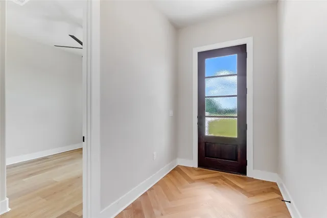 a view of kitchen with granite countertop cabinets and refrigerator