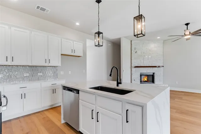 a view of an empty room with fireplace and a window