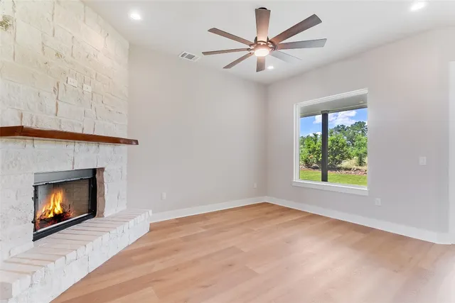 wooden floor in an empty room with a fireplace