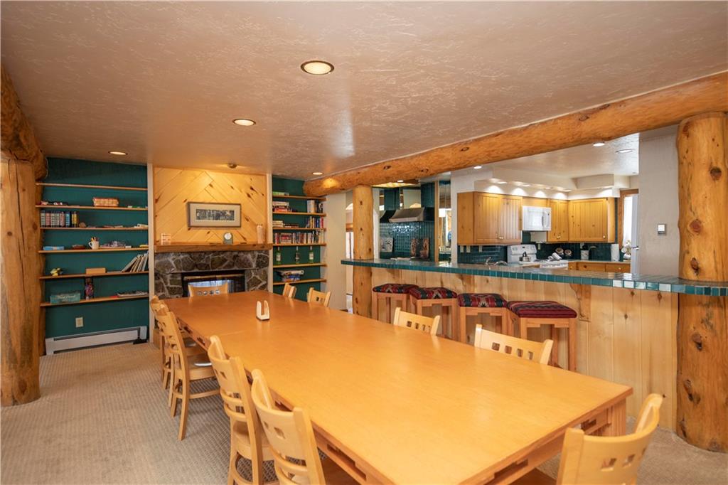 22 Keystone Gulch Road Keystone, CO 80435 - Photo 11 of 35 a dining table with chairs and kitchen view