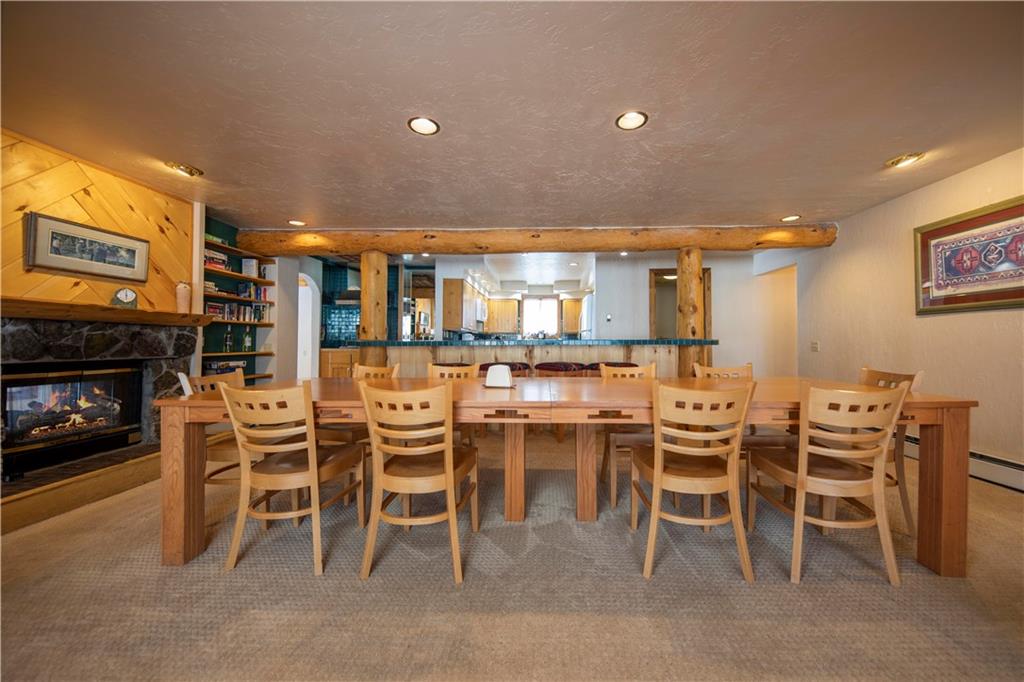 22 Keystone Gulch Road Keystone, CO 80435 - Photo 13 of 35 a dining table with chairs and kitchen view