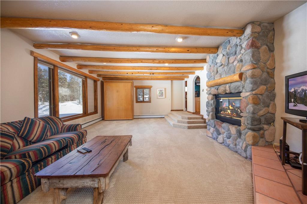 22 Keystone Gulch Road Keystone, CO 80435 - Photo 16 of 35 a living room with furniture and a fireplace