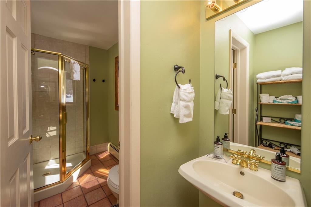 22 Keystone Gulch Road Keystone, CO 80435 - Photo 22 of 35 a bathroom with a sink mirror and shower