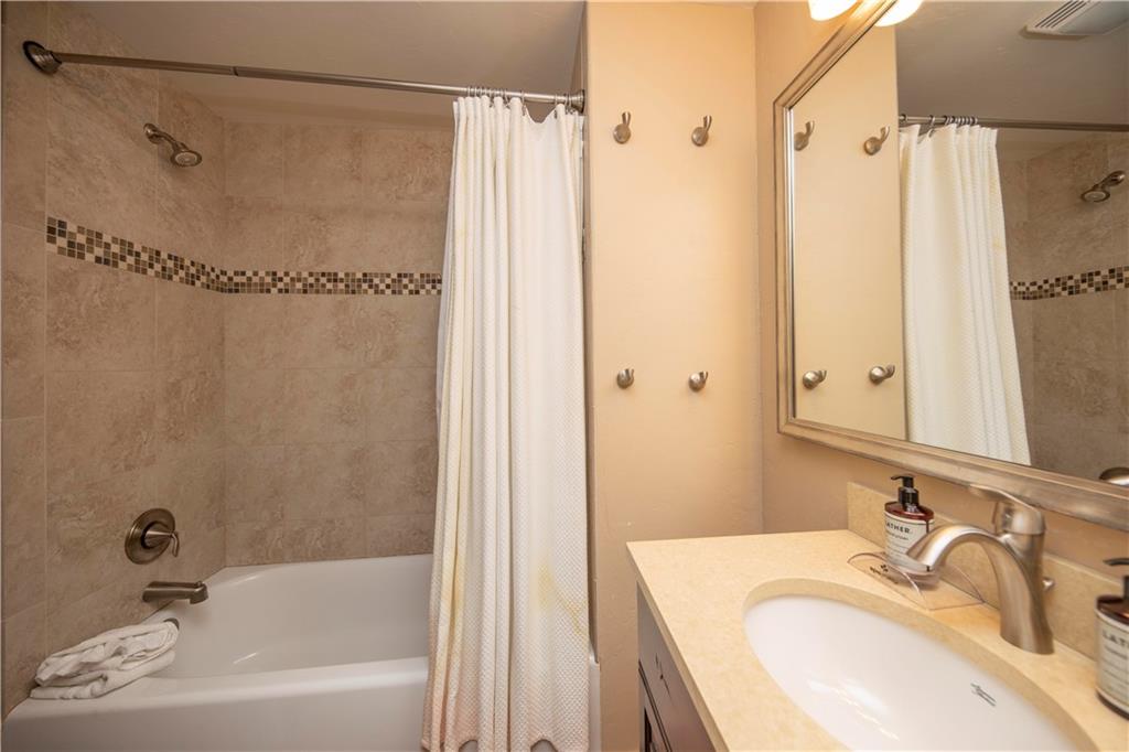 22 Keystone Gulch Road Keystone, CO 80435 - Photo 26 of 35 a bathroom with a granite countertop sink a mirror and a bathtub