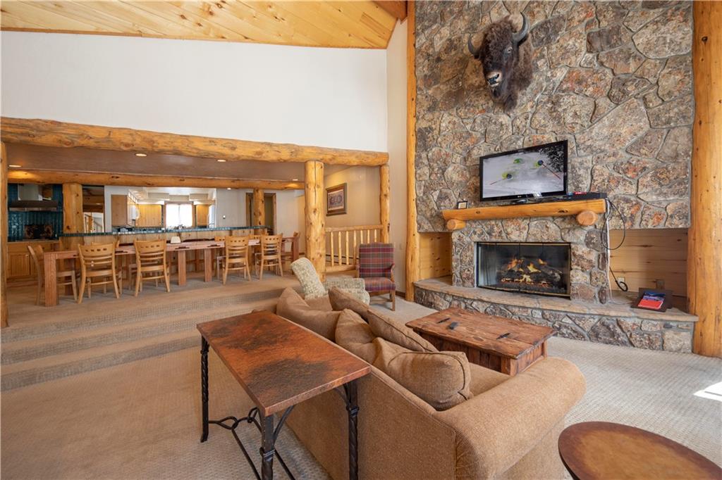 22 Keystone Gulch Road Keystone, CO 80435 - Photo 6 of 35 a living room with furniture a dining table and a fireplace