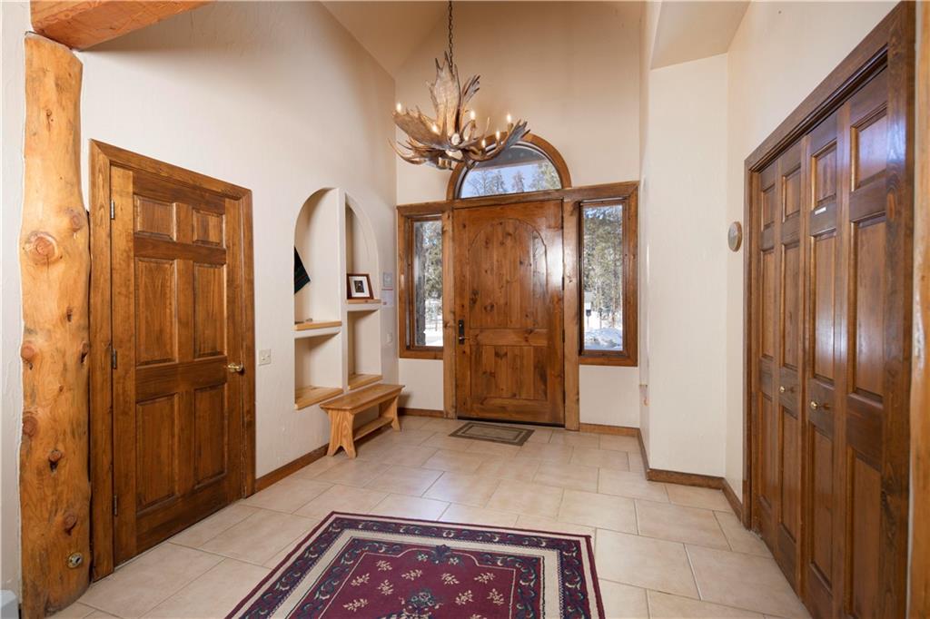 22 Keystone Gulch Road Keystone, CO 80435 - Photo 7 of 35 a view of a hallway with wooden floor and staircase