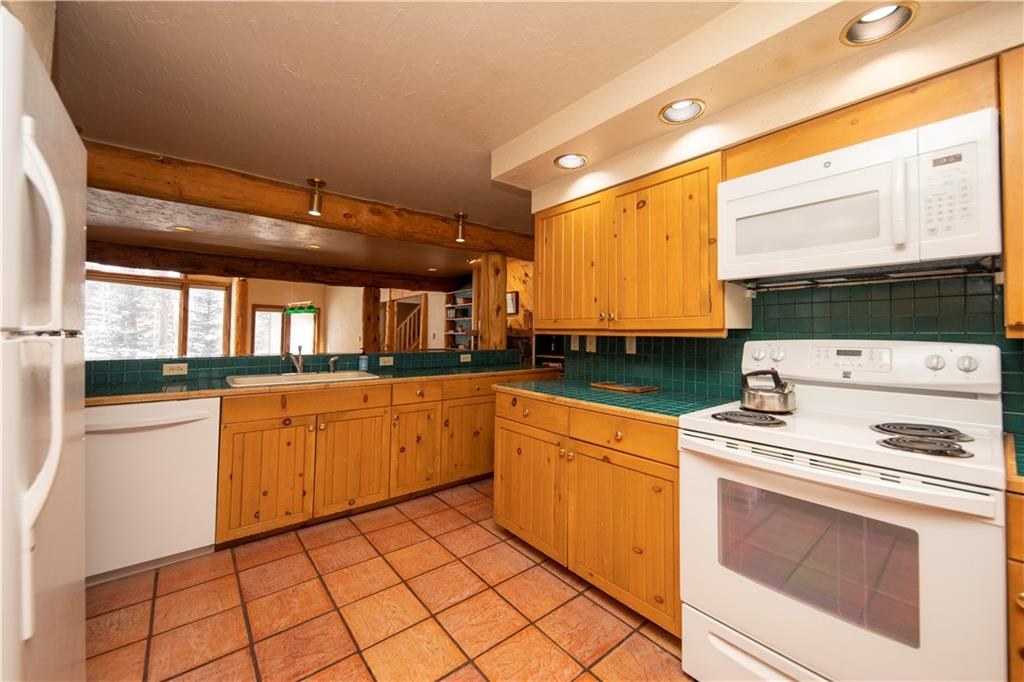 22 Keystone Gulch Road Keystone, CO 80435 - Photo 9 of 35 a kitchen with a stove sink and cabinets