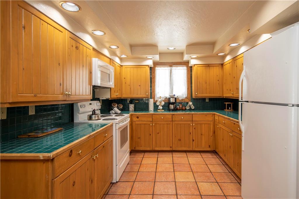 22 Keystone Gulch Road Keystone, CO 80435 - Photo 10 of 35 a kitchen with stainless steel appliances granite countertop a stove a sink and a microwave