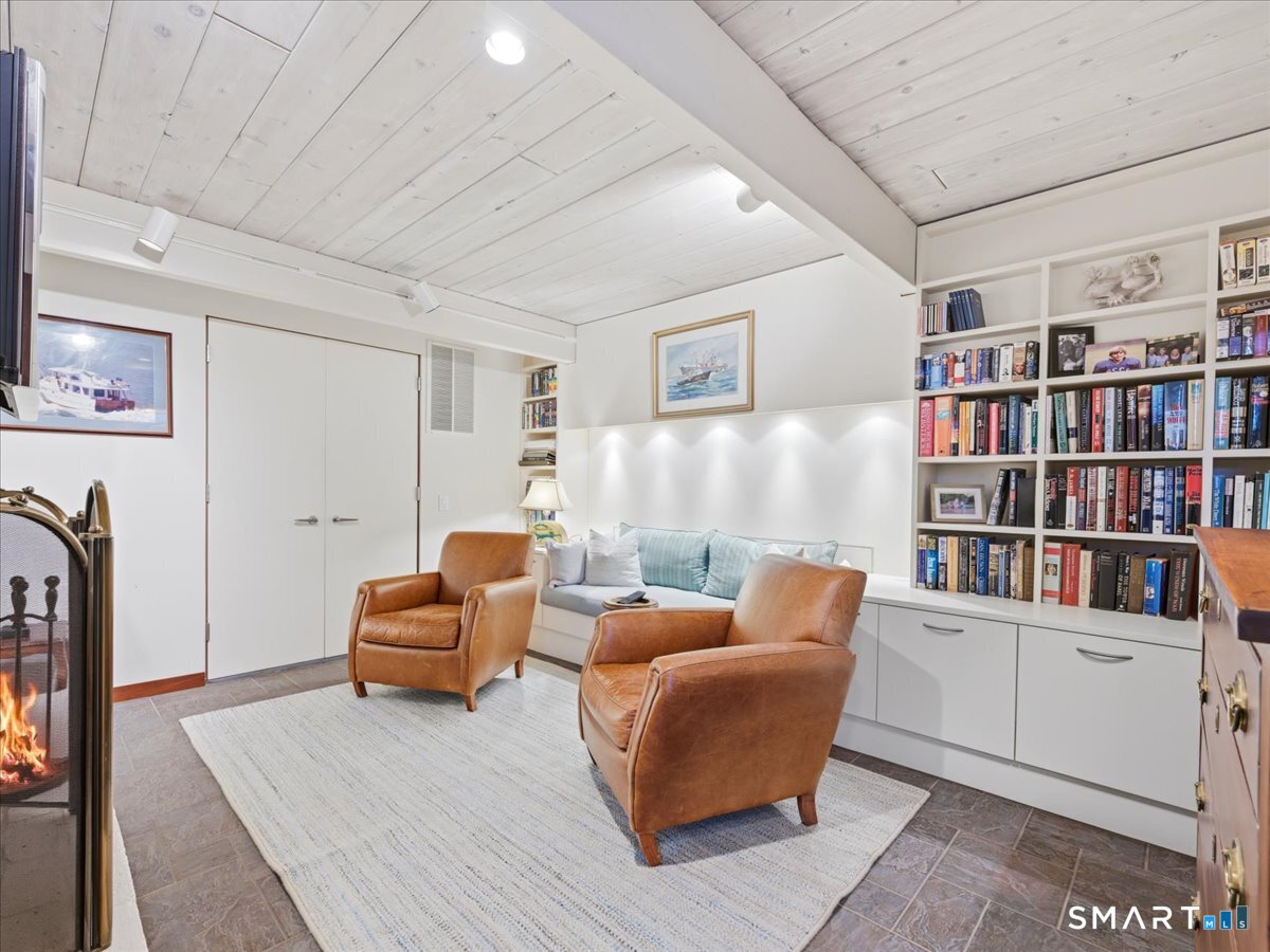 111 Tipping Rock Road Stonington, CT 06378 - Photo 24 of 40 Downstairs Den with Fireplace