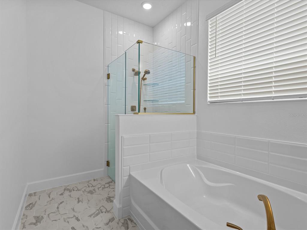 8018 Colby Circle Orlando, FL 32817 - Photo 12 of 32 a bathroom with a bathtub and a shower