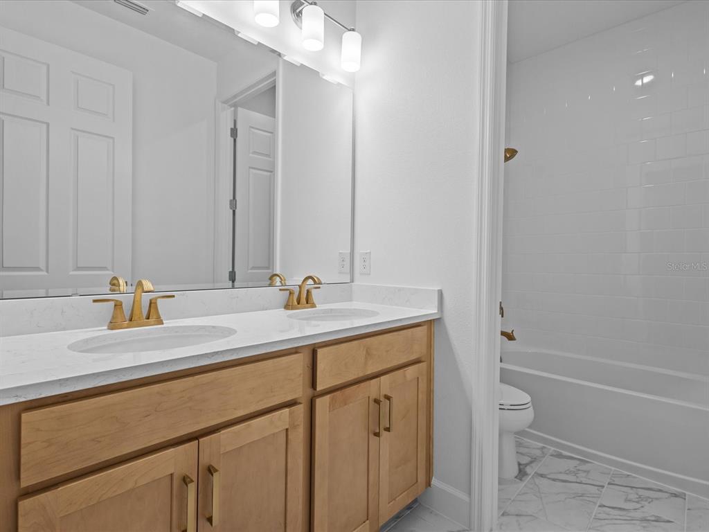 8018 Colby Circle Orlando, FL 32817 - Photo 14 of 32 a bathroom with a sink and a mirror with bathtub